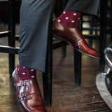 Man wearing Burgundy men's dress socks with white polka dots