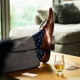 Navy blue men's patterned dress socks with white dots