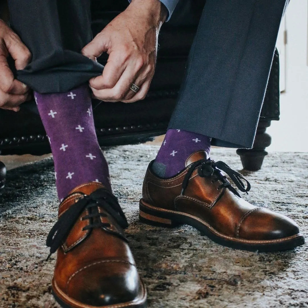 Man wearing purple dress socks with white hatches and brown dress shoes