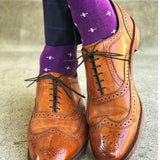 Man wearing purple dress socks with white hatches and brown dress shoes
