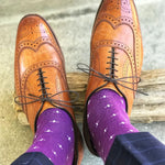 Man wearing purple dress socks with white hatches and brown dress shoes