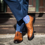 guy wearing blue slacks, blue socks, and tan shoes