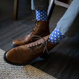 guy wearing grey pants, blue socks, and brown boots