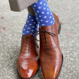 Man wearing heathered blue socks with white hatches and dress shoes