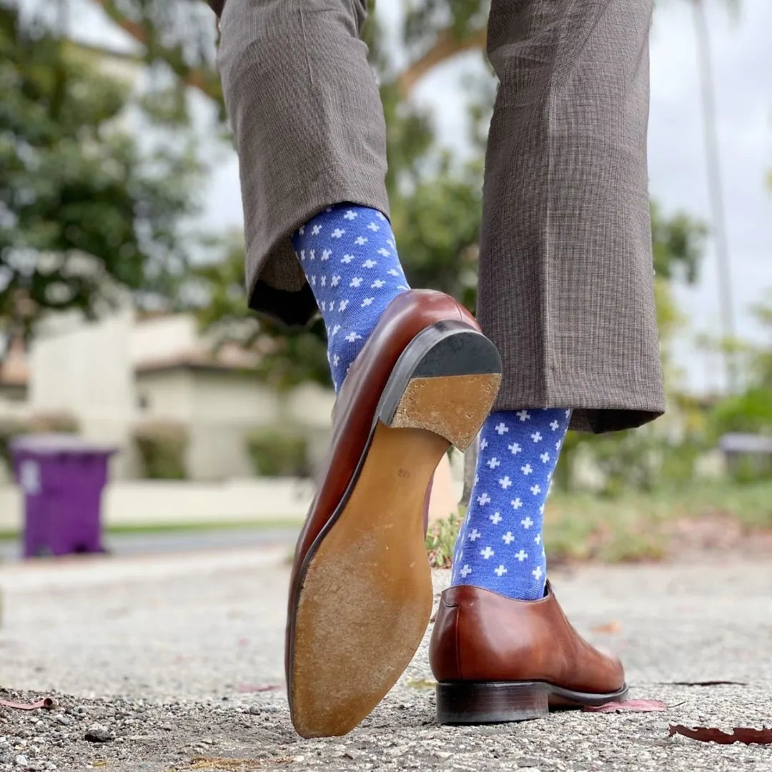 Man wearing heathered blue socks with white hatches and dress shoes