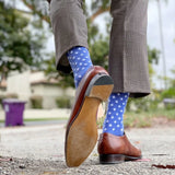 Man wearing heathered blue socks with white hatches and dress shoes