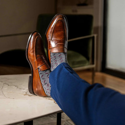 The Neufelds - A Grey Sock With a Deep Red & Black X Pattern