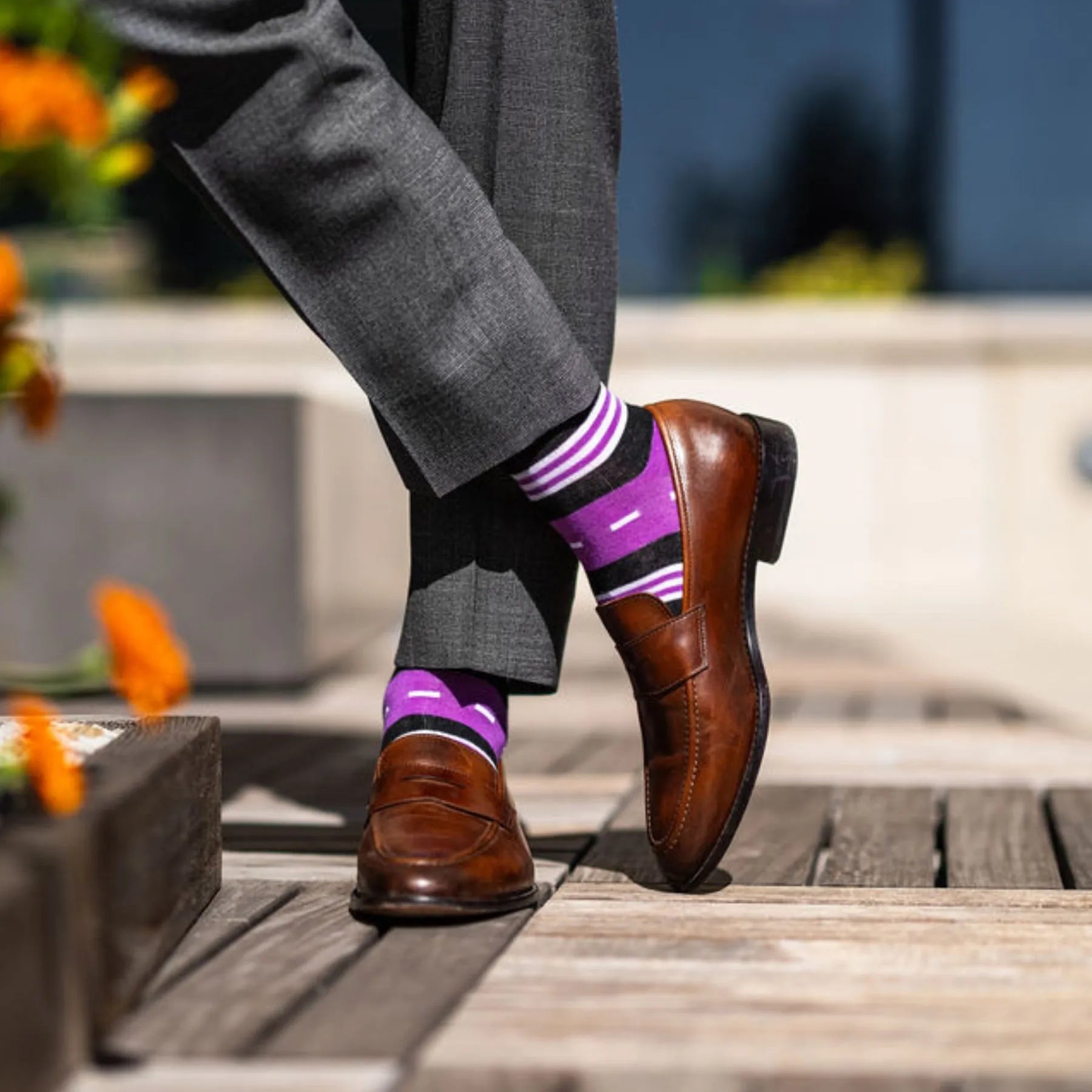 Vibrant purple men's dress sock with unique white and black stripe pattern