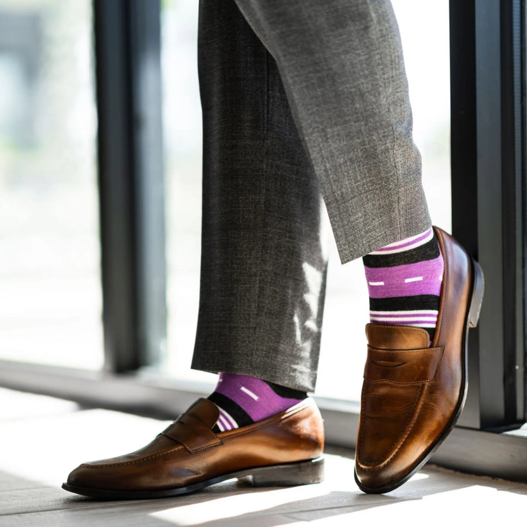 Vibrant purple men's dress sock with unique white and black stripe pattern