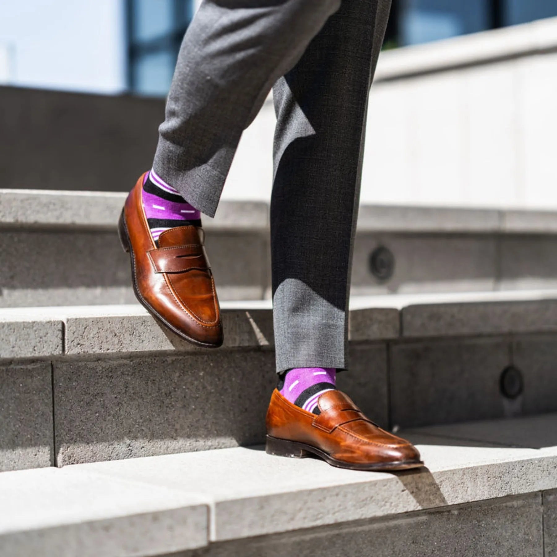 Vibrant purple men's dress sock with unique white and black stripe pattern