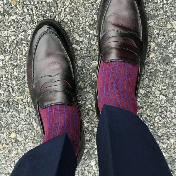 man wearing blue and red pinstripe dress socks