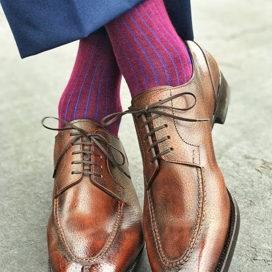 Man wearing blue and red pinstripe dress socks