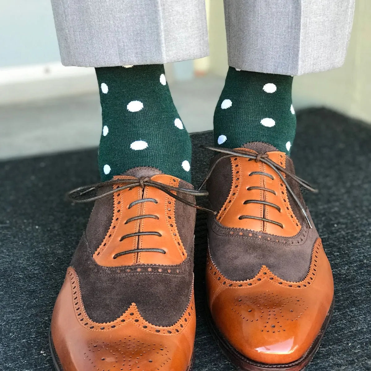 Man wearing green socks and brown shoes