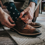 Man wearing green socks with white polka dots