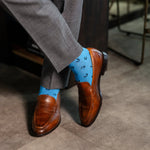 light blue men's dress socks with a black horseshoe pattern