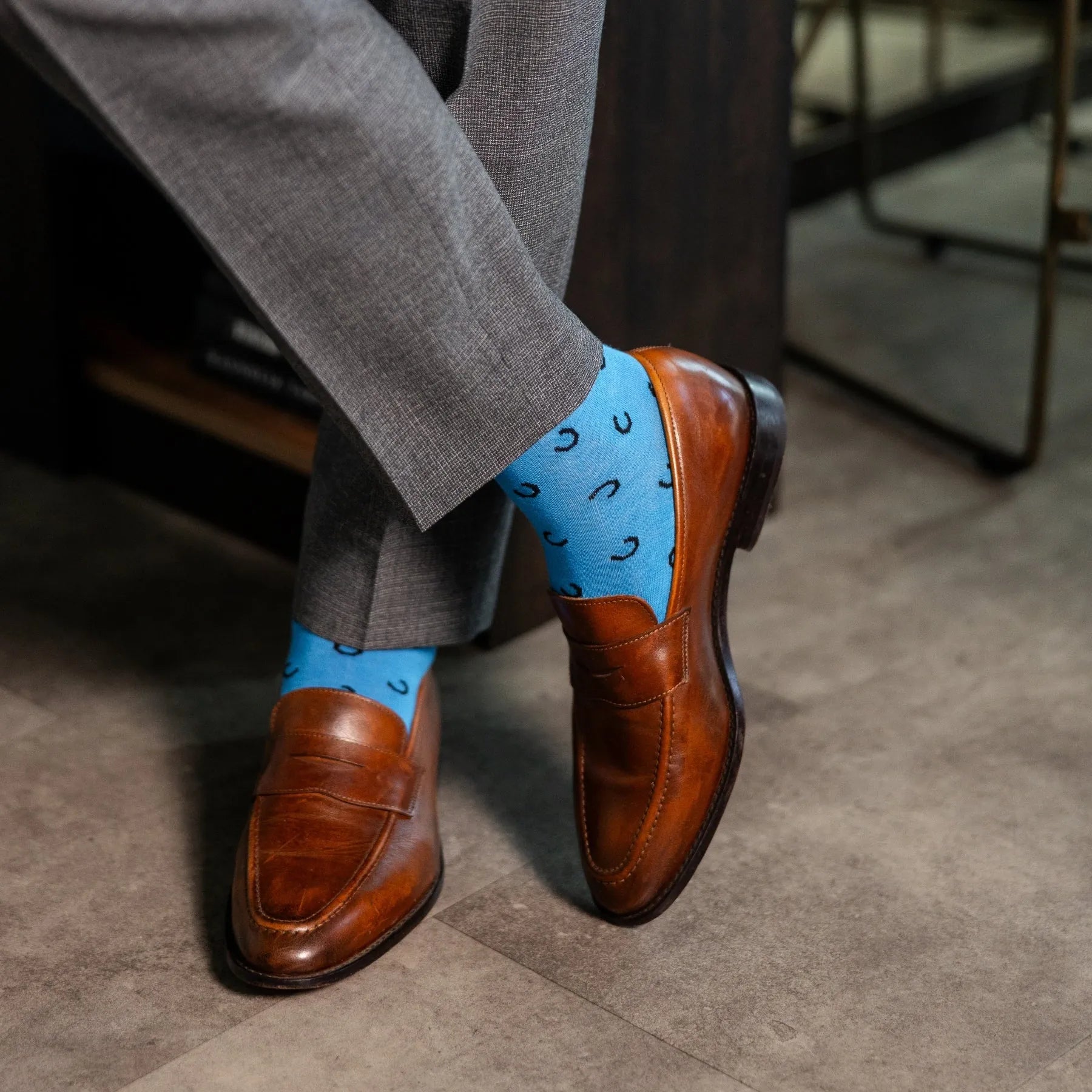 light blue men's dress socks with a black horseshoe pattern