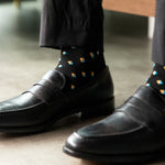 A Black Sock Gentleman's Sock with a Peach, Sky Blue, and White Gemstone Pattern