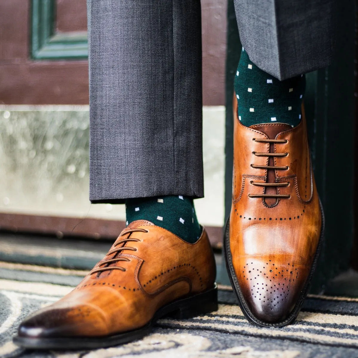 guy wearing grey slacks, green socks, with tan dress shoes