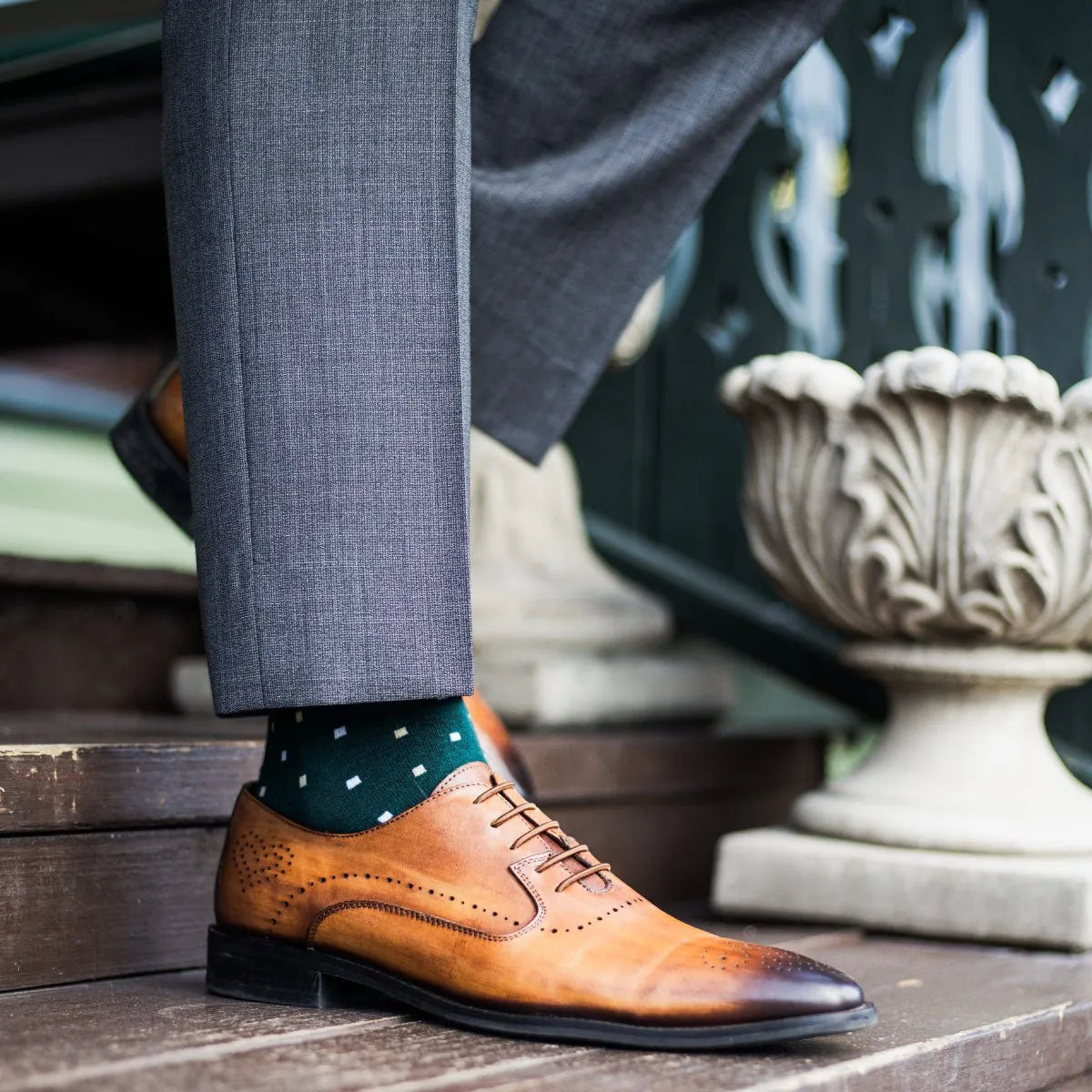 guy wearing grey slacks, green socks, with tan dress shoes