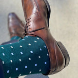 Man wearing green socks with white micro-squares and dress shoes