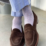 Guy wearing light grey men's dress socks with baby blue pin dot pattern