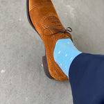 navy blue pants, baby blue and white polka dot socks, and tan shoes.