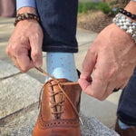 Man wearing blue socks and jeans