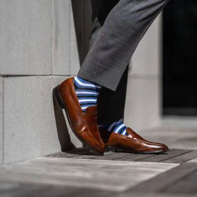 The Trevinos - A Blue, Black, and White Striped Sock