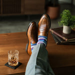A blue, red, and grey striped men's dress sock