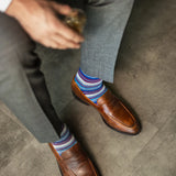 A blue, red, and grey striped men's dress sock