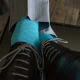 Turquoise blue men's dress sock with white contrasting diamond pattern
