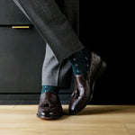 deep green men's dress sock with a white t-sun pattern