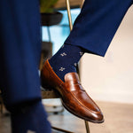 Navy men's dress socks with a gold flower pattern