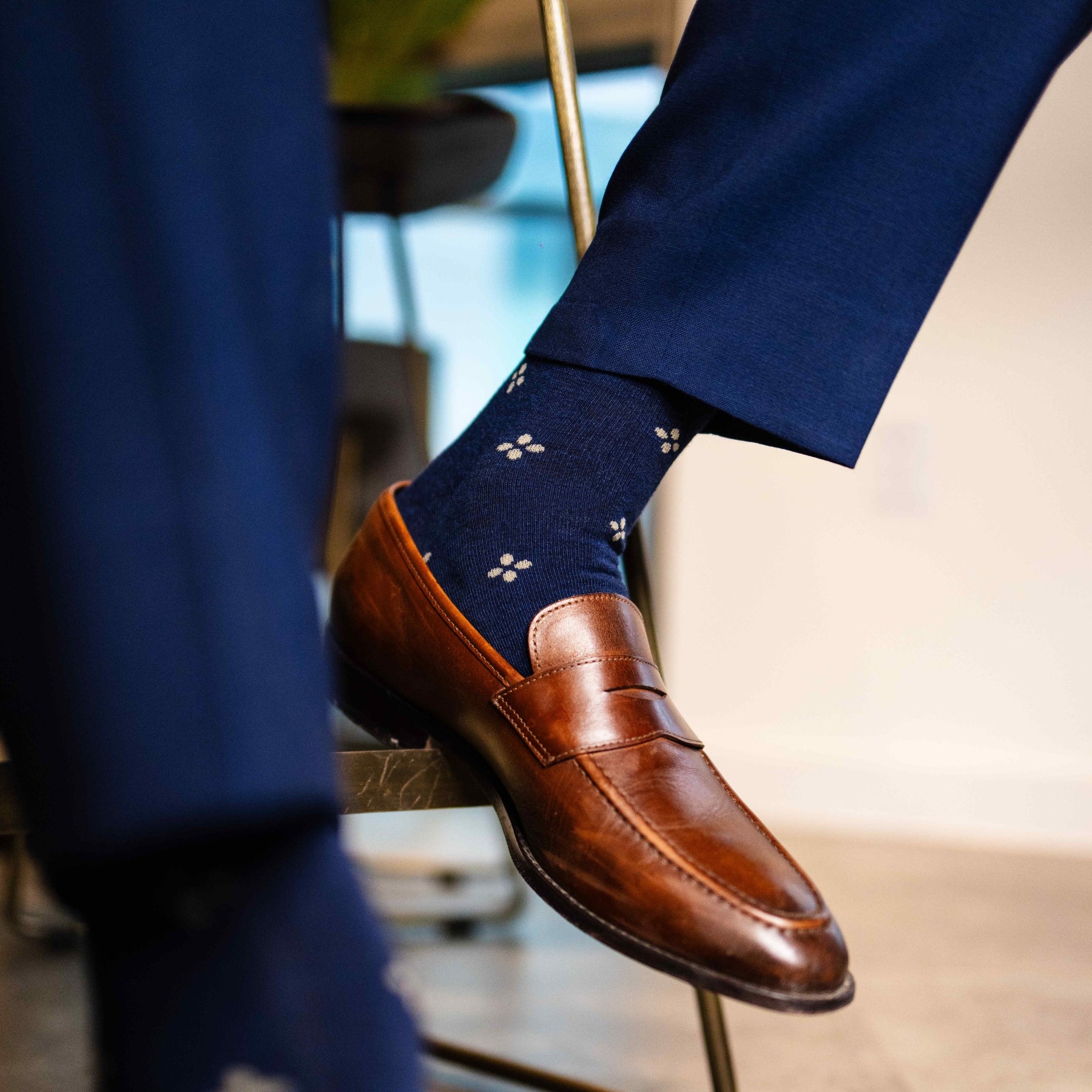 Navy men's dress socks with a gold flower pattern