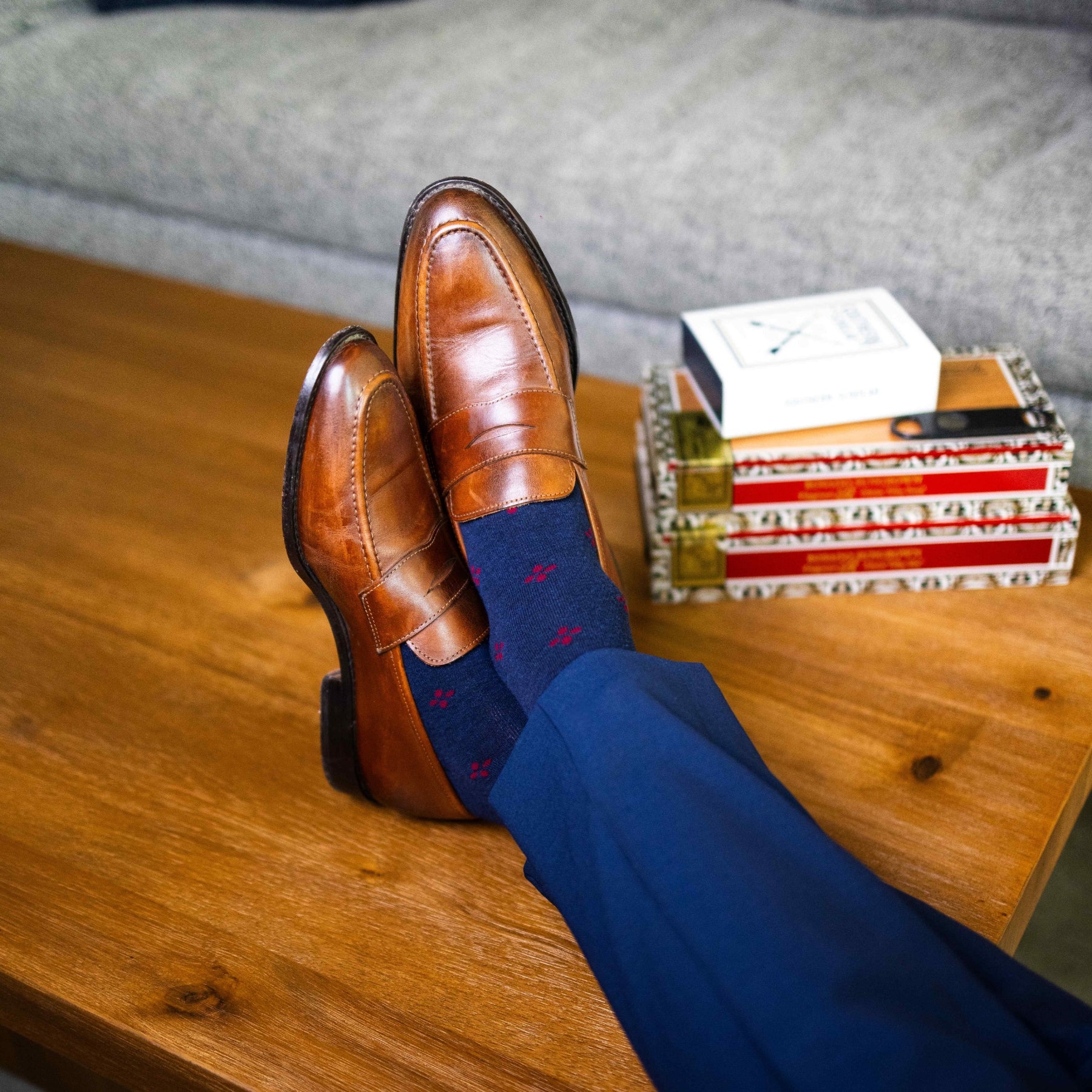 Navy blue men's sock with a garnet red flower pattern
