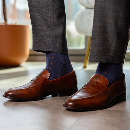 a deep blue sock with gold a gold t-sun pattern