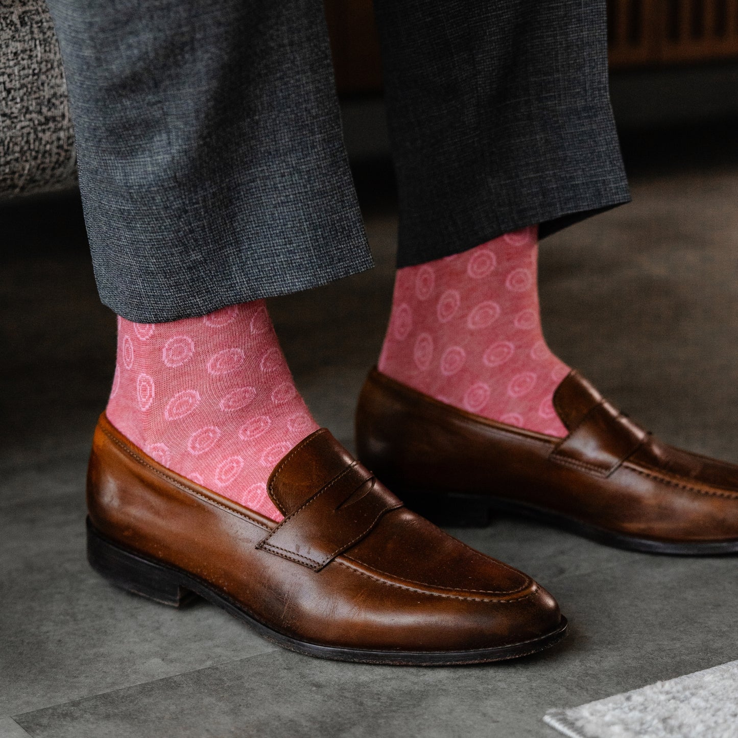 A coral men's dress sock with a blush pink double dot pattern