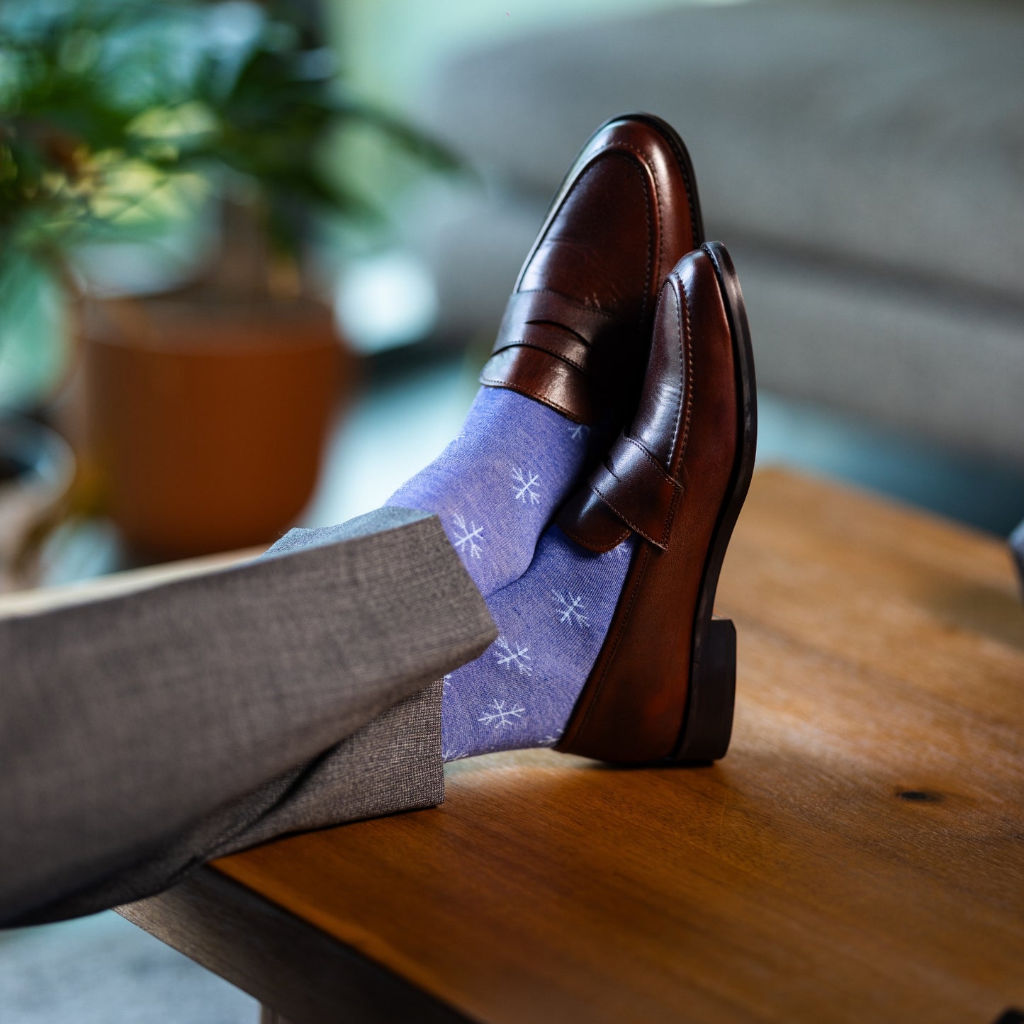 A Heathered Blue men's dress sock with a light blue snowflake pattern