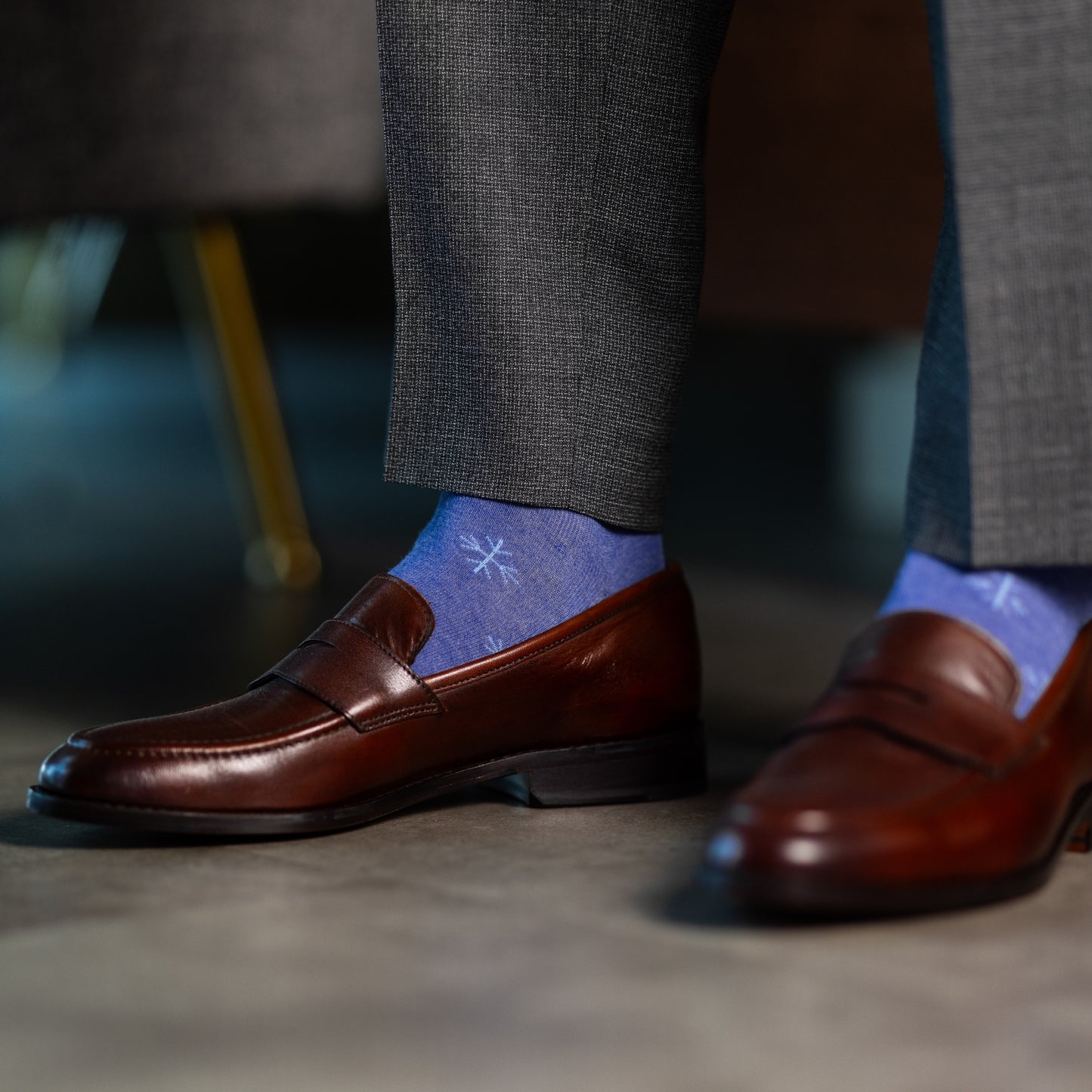 A Heathered Blue men's dress sock with a light blue snowflake pattern