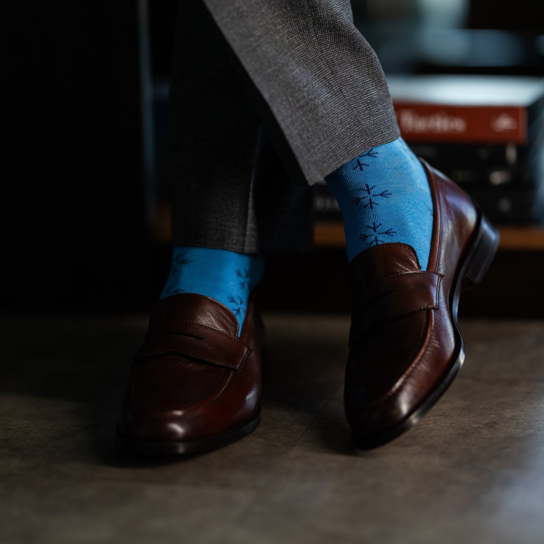 an Icy Blue men's dress sock with a navy blue snowflake pattern