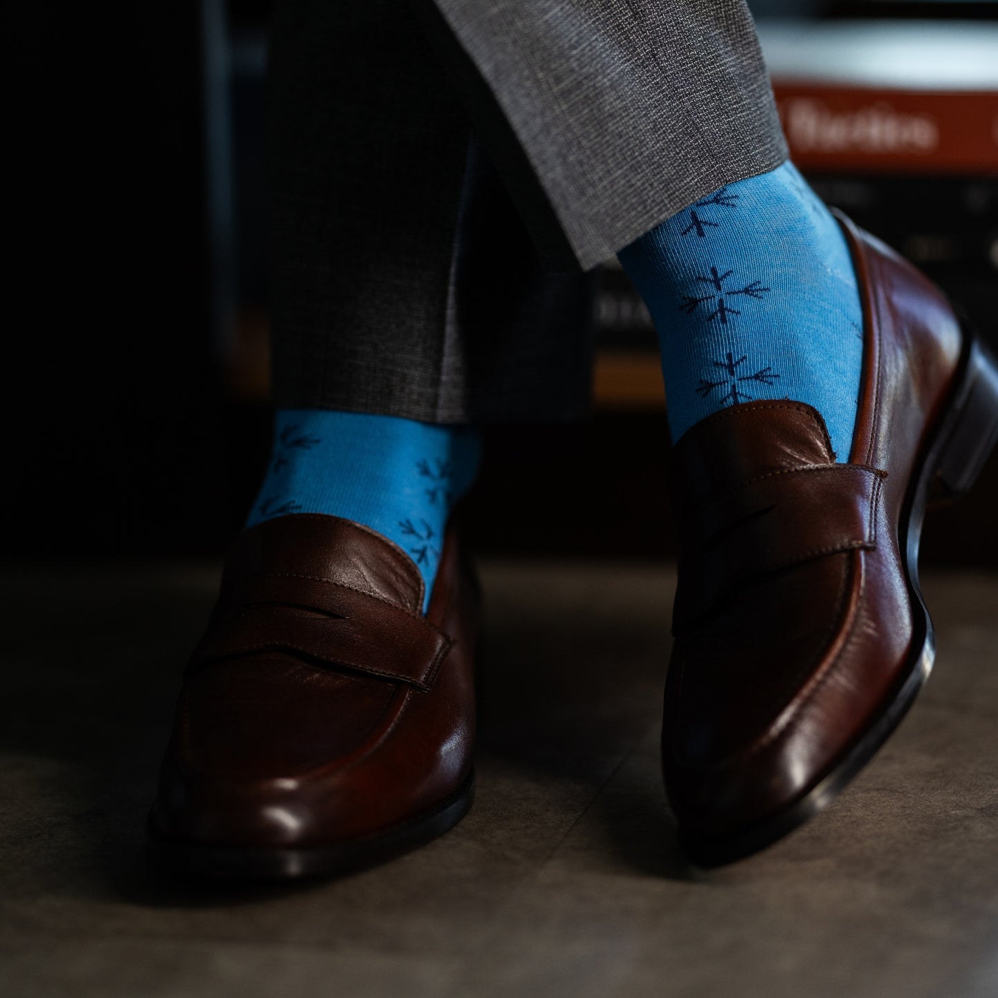 an Icy Blue men's dress sock with a navy blue snowflake pattern