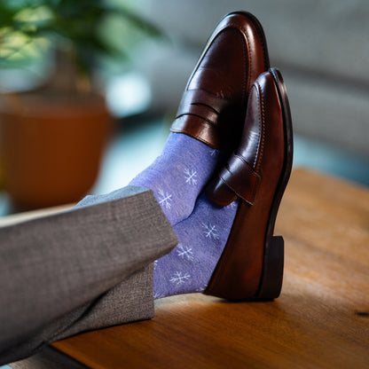 A Heathered Blue men's dress sock with a light blue snowflake pattern