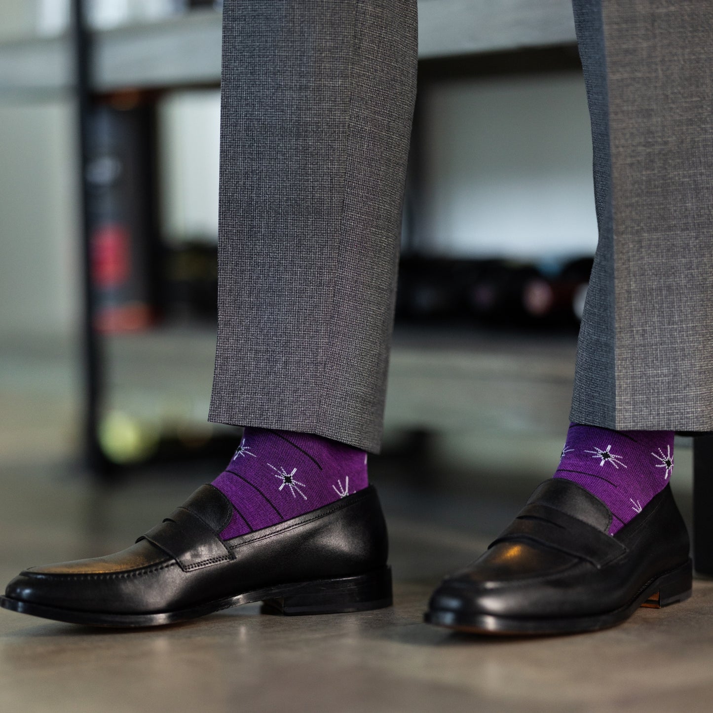 A plum purple men's dress sock with a white and black constellation and stripe pattern