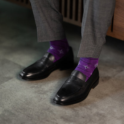 A plum purple men's dress sock with a white and black constellation and stripe pattern