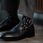 A charcoal men's dress sock with a white and cream speckled pattern