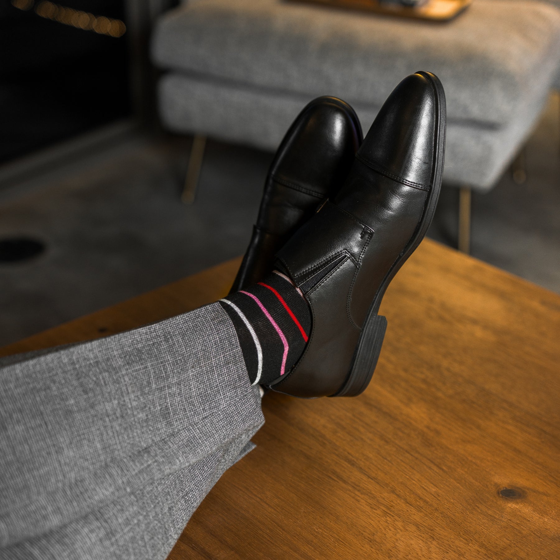 A classic black sock with varying hues of pastel red, pink, peach and arctic blue, perfect for spring and summer!