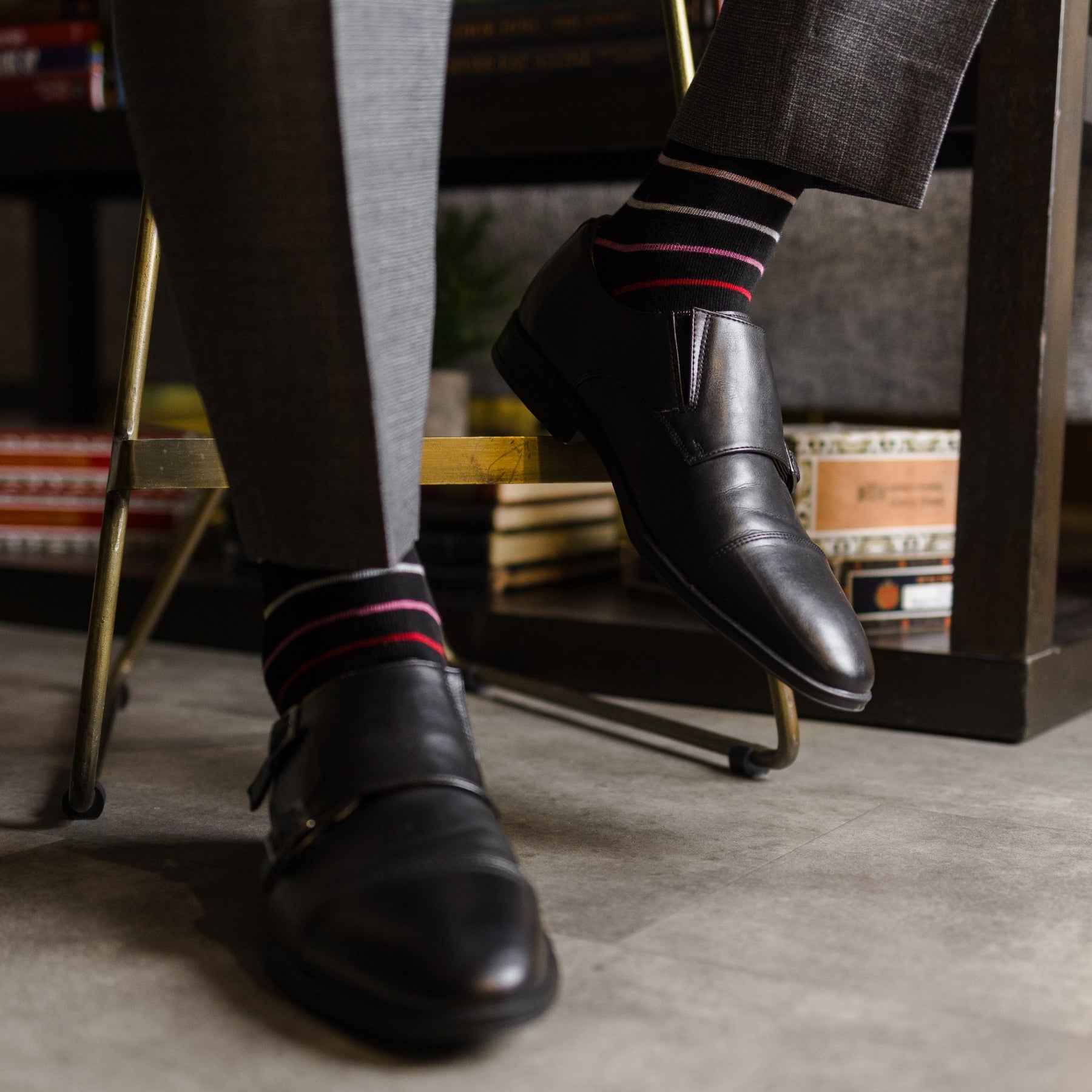 A classic black sock with varying hues of pastel red, pink, peach and arctic blue, perfect for spring and summer!