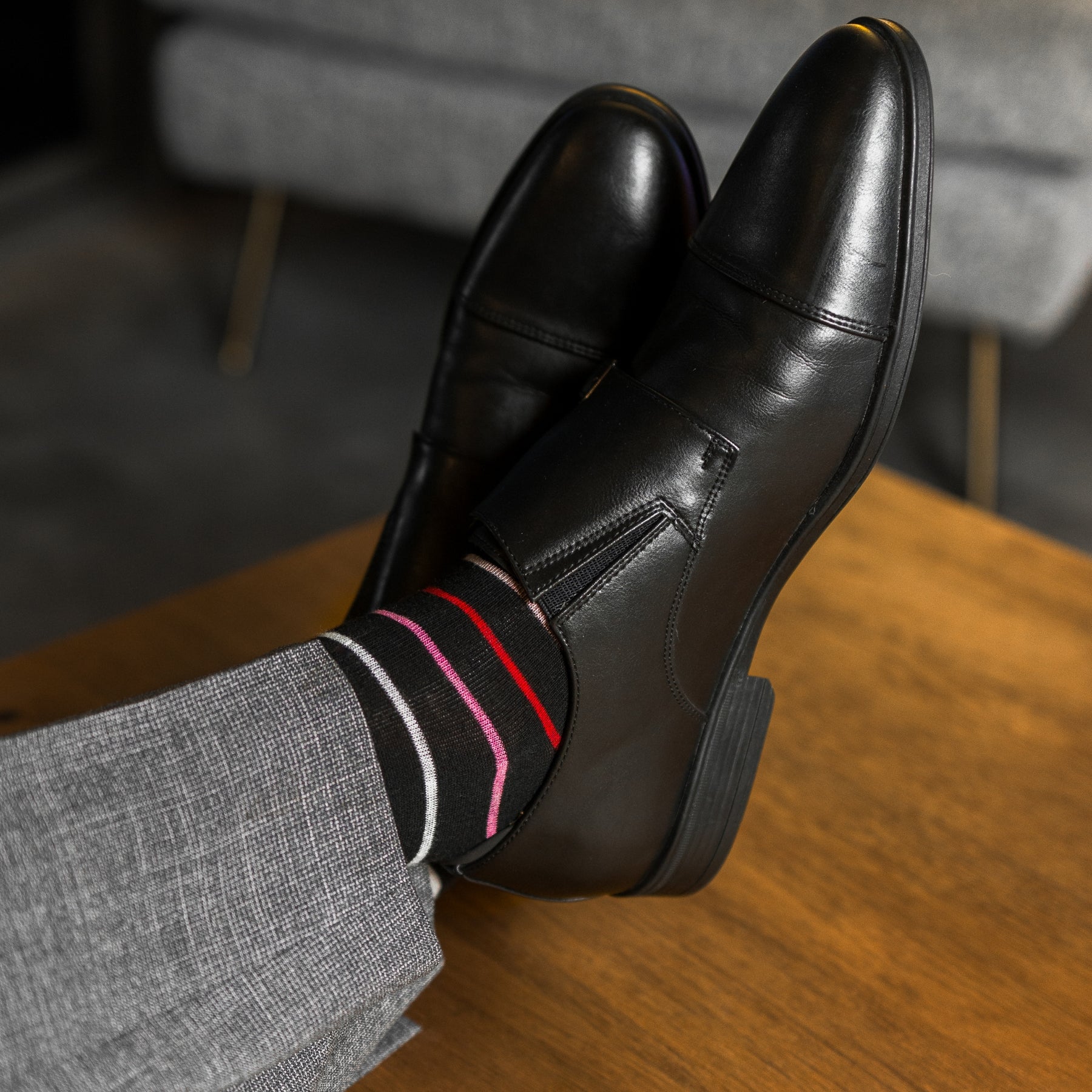 A classic black sock with varying hues of pastel red, pink, peach and arctic blue, perfect for spring and summer!