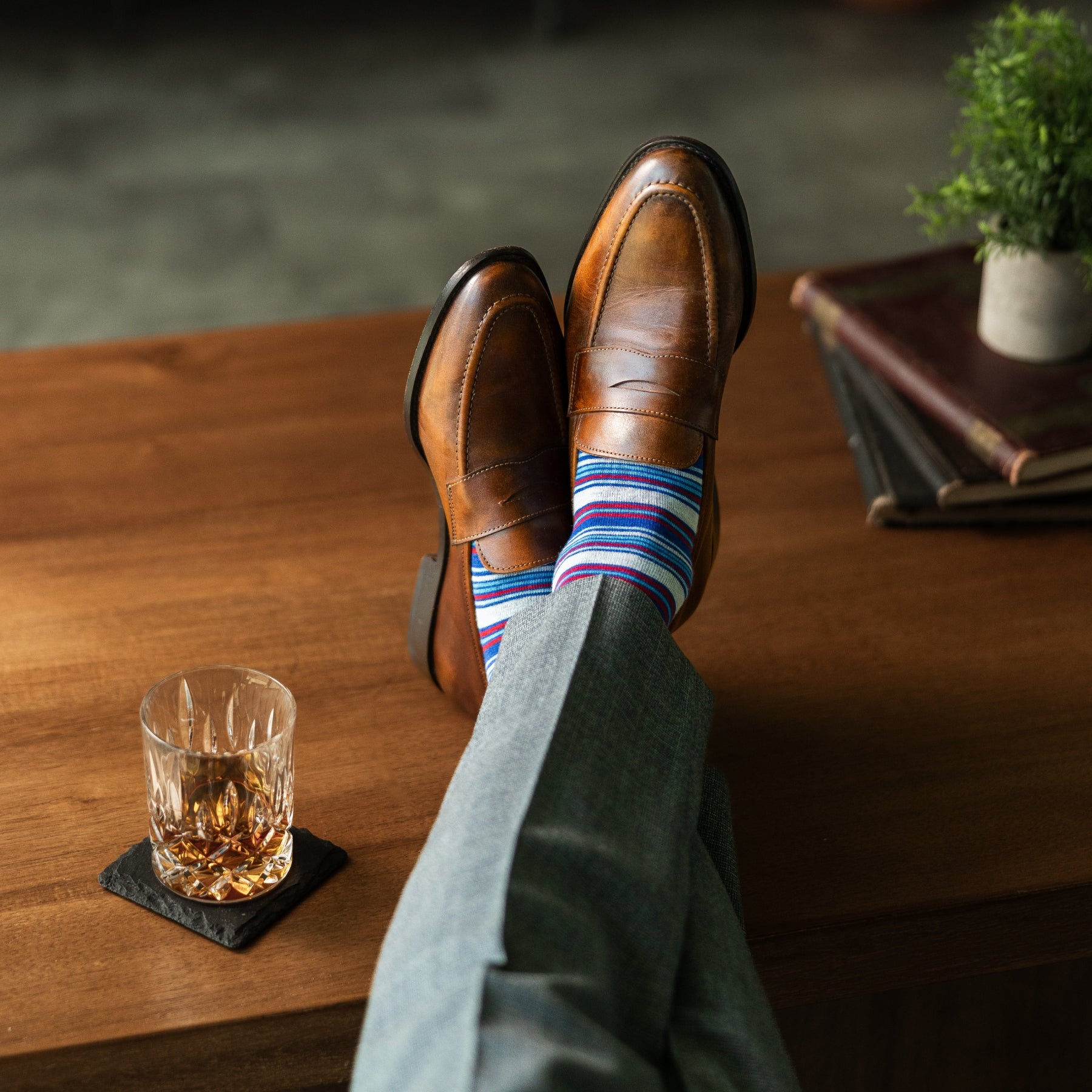 A blue, red, and grey striped men's dress sock