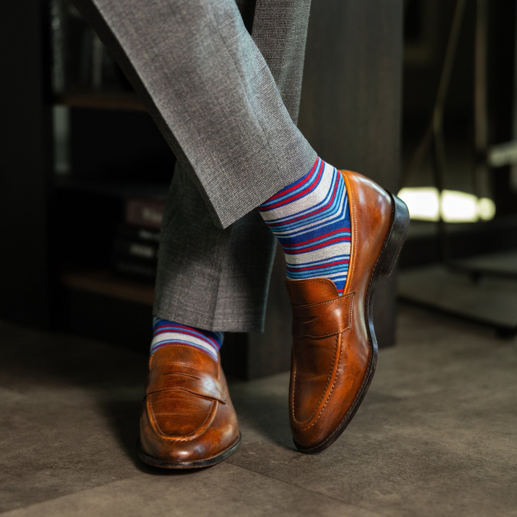 A blue, red, and grey striped men's dress sock
